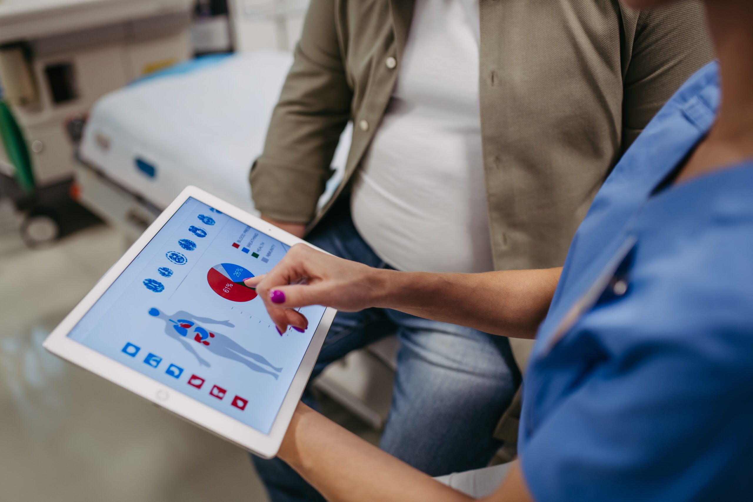 Doctor presenting patient insights on a tablet.