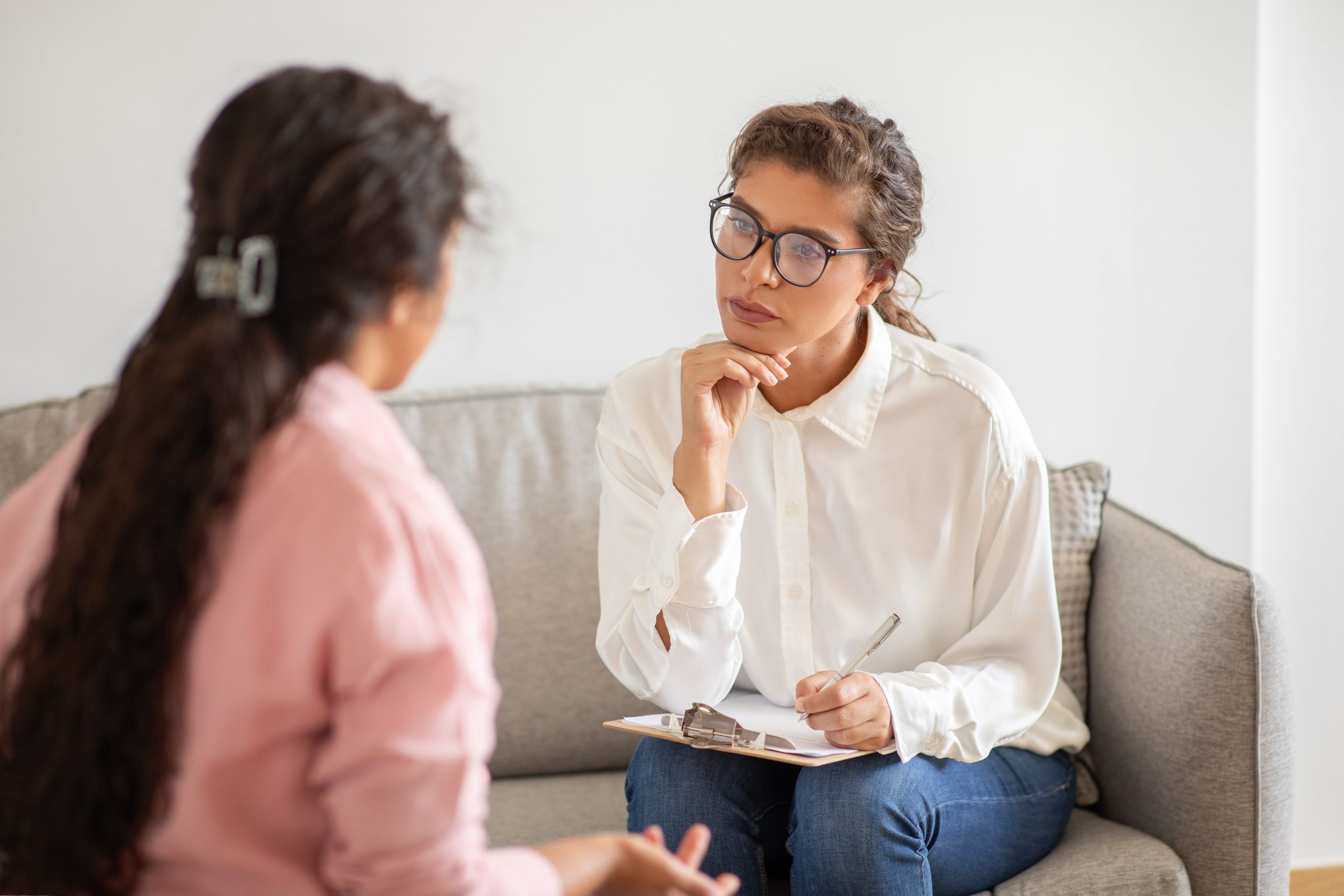 Two individuals in a professional setting discussing regulatory data collection with a patient-centered focus, symbolizing VCLS's support for clinical compliance.